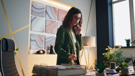 businesswoman have phone conversation standing office. girl talking telephone