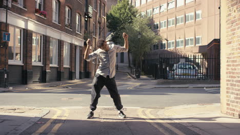 Contemporary-funky-mixed-race-man-street-dancer-dancing-freestyle-in-the-city