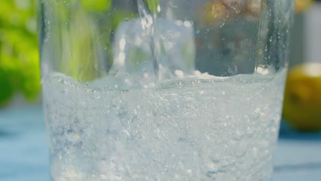 refreshing beverage poured into glass with ice