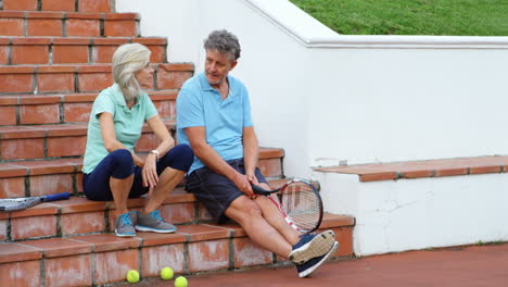 senior couple talking on stairs 4k