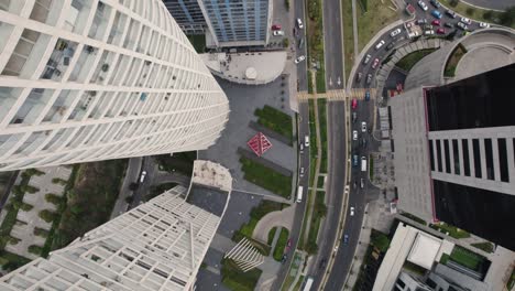 Aerial-view-of-Mexico-City-with-modern-skyscrapers,-streets,-and-urban-plaza