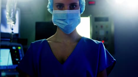 portrait of female surgeon standing with arms crossed in operating room
