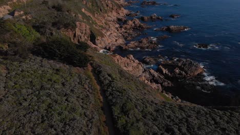 Dirt-hiking-path-along-highway-one-along-rocky-cliffs,-near-Big-Sur,-California