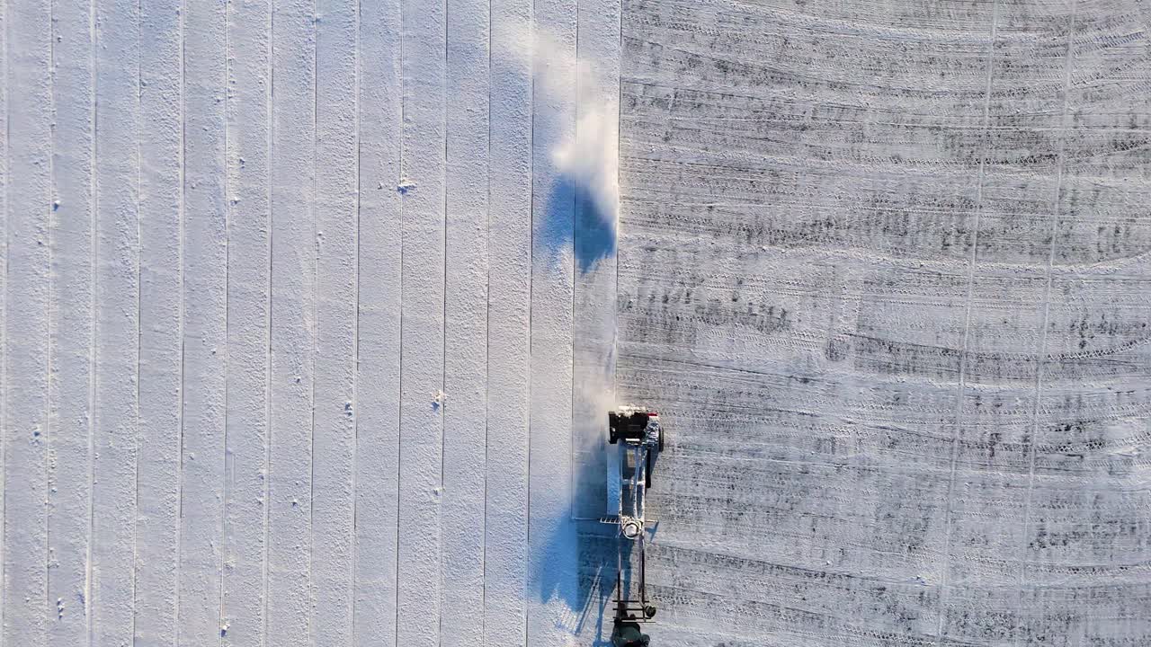 Top-down drone shot of ice block-cutting machine at Harbin Ice Festival in Heilongjiang, China