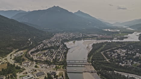 revelstoke bc canada aerial v4 drone flyover sobre el río columbia capturando el paisaje pintoresco de la zona residencial de la orilla del río, el centro de la ciudad y las montañas boscosas - filmado con mavic 3 pro cine - julio 2023