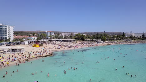 aerial shot of a beautiful sandy beach with water sports and beach facilities