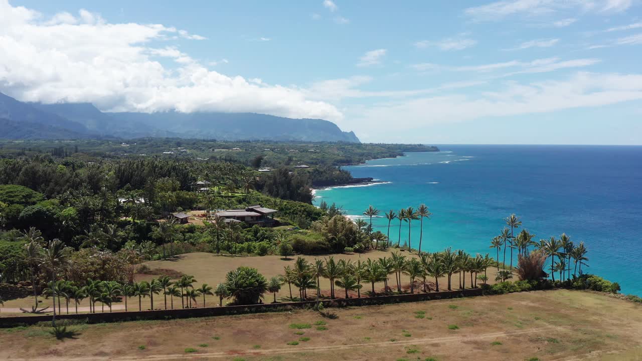 Low aerial shot flying over the North Shore coastline of Kaua'i, Hawai'i