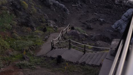 scary dark ancient staircase leads to black volcanic beach