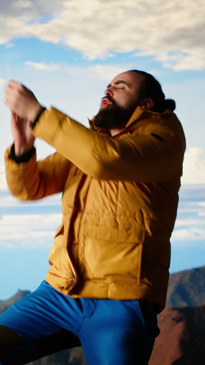 Homem Enérgico Dançando e Gritando de Alegria no Topo de uma Montanha