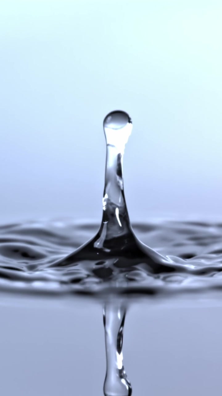 Slow Motion Water Droplet Falling and Creating a Crown Splash and Ripples