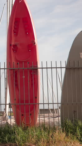 surfboards resting on fence in barcelona in vertical