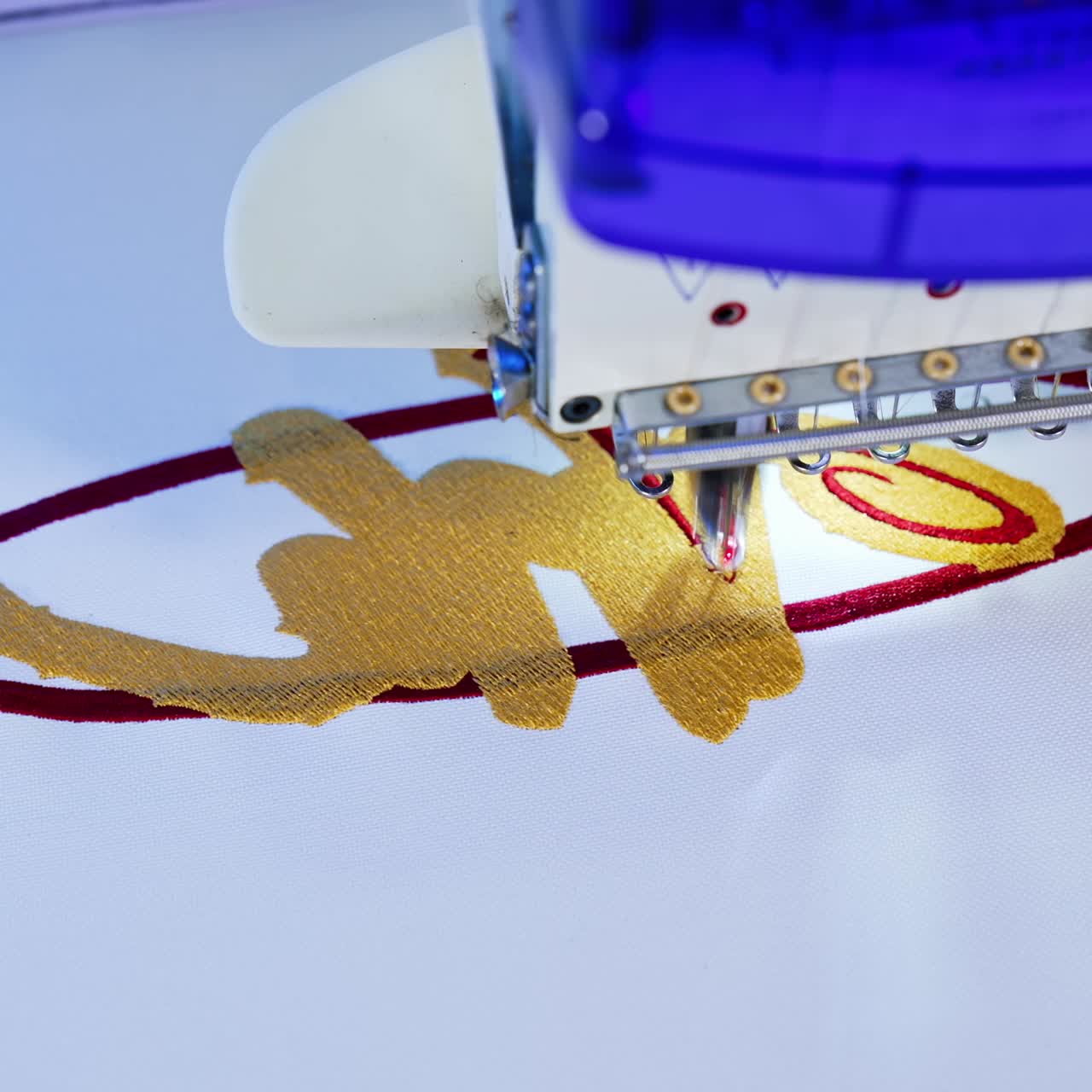 Automatic embroidery machine in factory. Embroidery area in textile factory in industrial zone