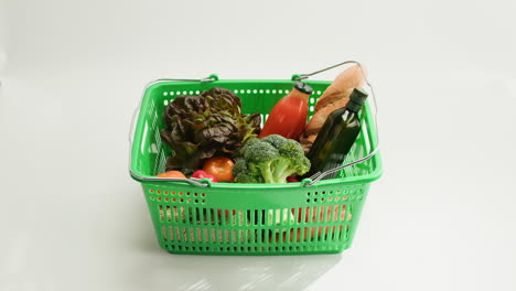 woman shopping with a basket filled with groceries