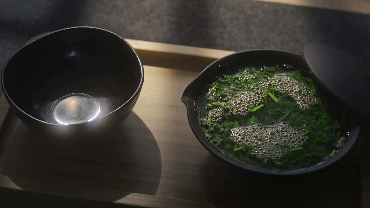 Pouring green leaves of Japanese gyokuro tea in shiboridashi is a ritual associated with longevity and good health