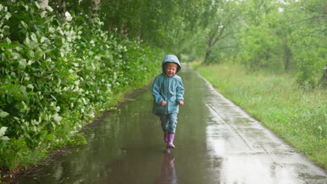 a young girl walks down a wet path in the rain