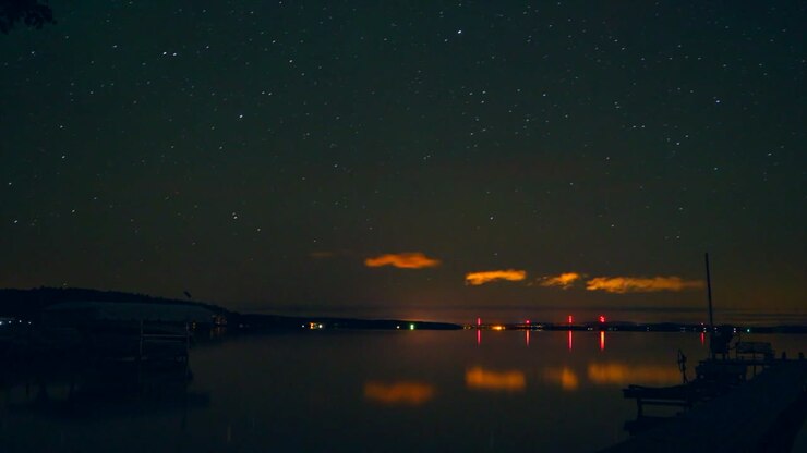 Burt Lake Northern up north Michigan night time lapse Timelapse evening cloudy calm lake orange lights movement docks with boats Harbor Springs Petosky Great Lakes Mackinaw still movement