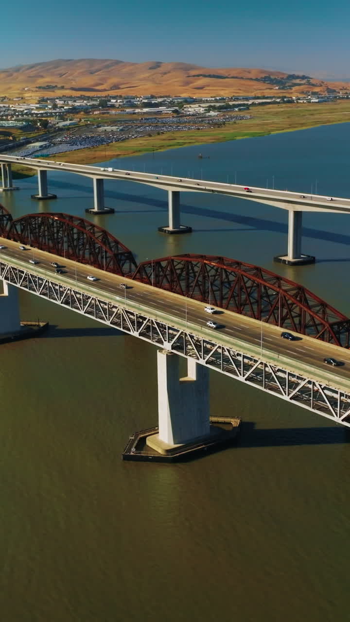 Bridges with highways to both sides. Roads on bridges connecting Martinez to Benicia. Sunny day view from top. Vertical video