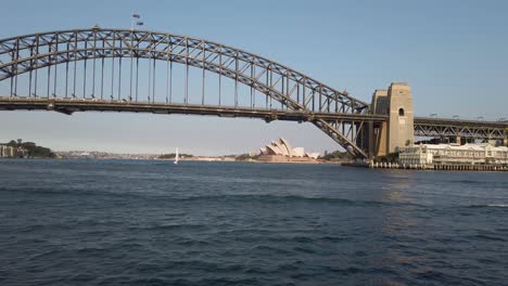 view of harbour bridge with opera house in background during sunset in sydney, nsw, australia - wide shot