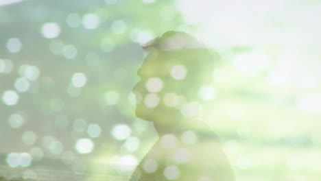 animation of light reflection over happy caucasian man on beach