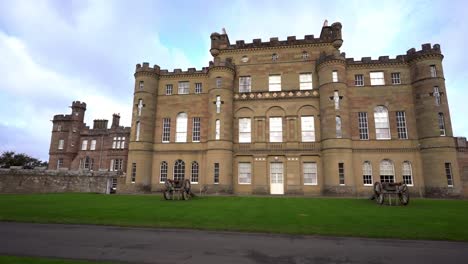 pan shot in front of the culzean castle, on a partly sunny day, in carrick, south west scotland, uk