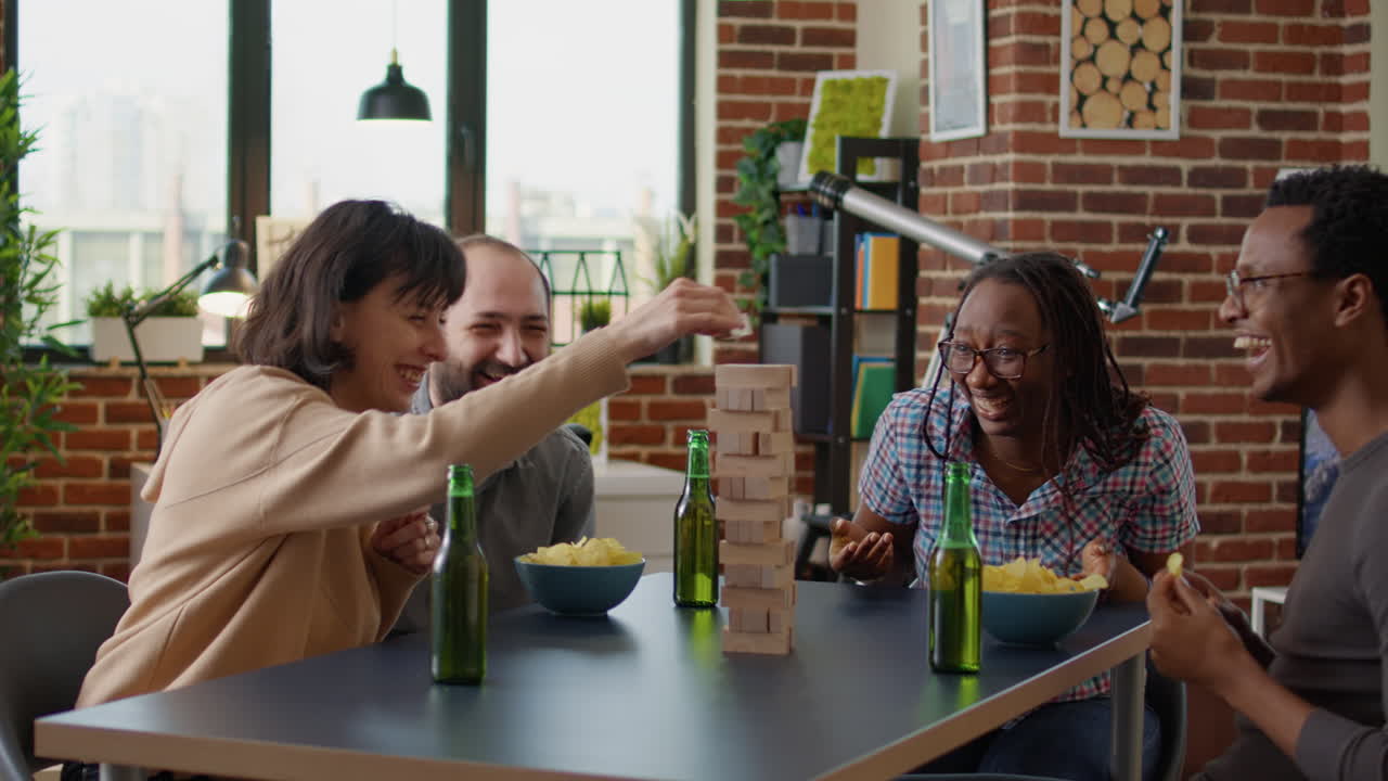 Men and women laughing while they play society game
