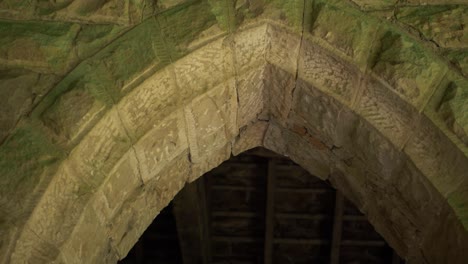 arched doorway entrance on old stone building medium panning shot