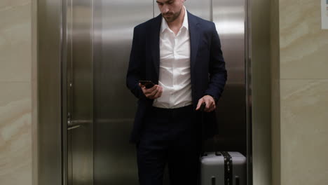 Man-exiting-the-elevator-in-the-hotel-hall