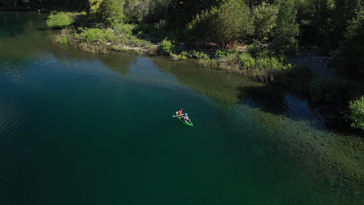 descenso aéreo de un par de pescadores con mosca seca cualificados capturando truchas cerca de la orilla del lago steffen, patagonia argentina