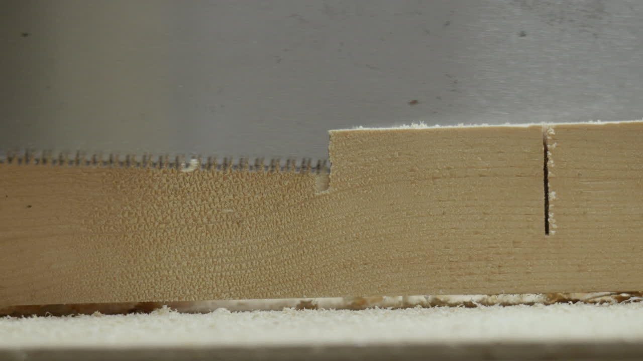 Carpenter sawing with japan hand saw