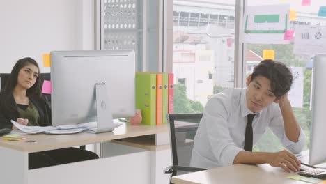 young asian colleagues feeling bored in office