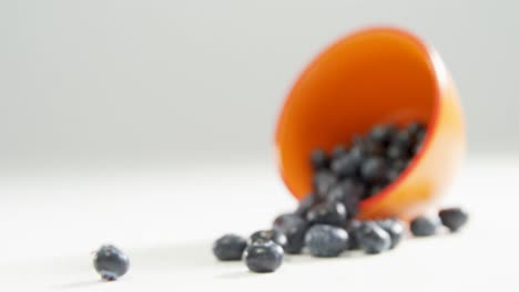 blueberries spilling out from bowl on white surface 4k 4k