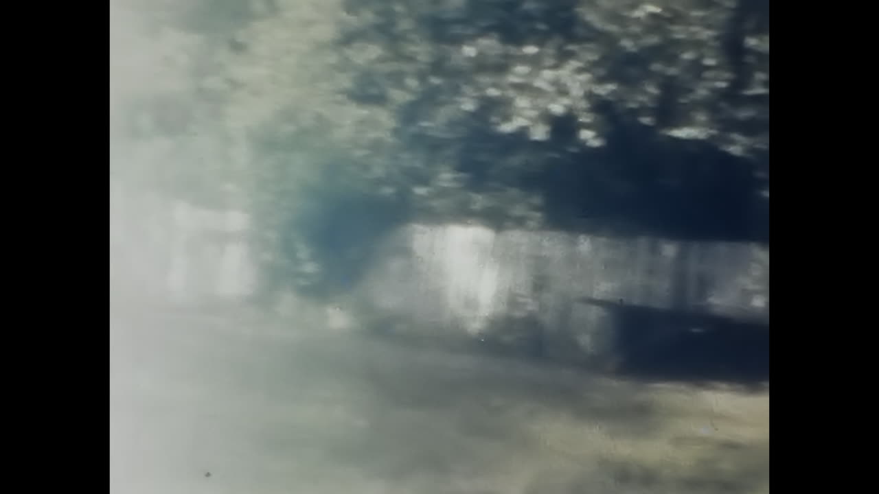 Man Standing in Front of Fence in Soviet Union Archive. CIRCA USSR 1980s: A man stands in front of a fence in an archival image from the Soviet Union.