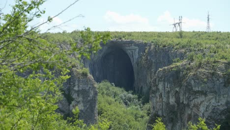 hole to the prohodna karst cave, god's eyes near karlukovo in lukovit, bulgaria