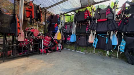 Life-jackets-and-boat-paddles-hanging-in-the-shop-room