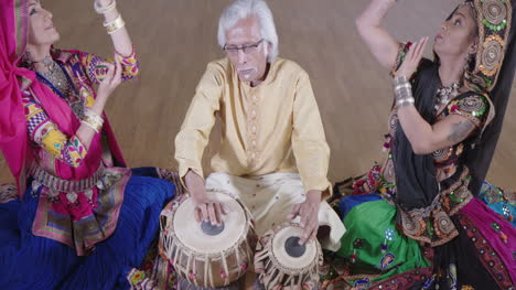 indian percussion musician with dancers 11