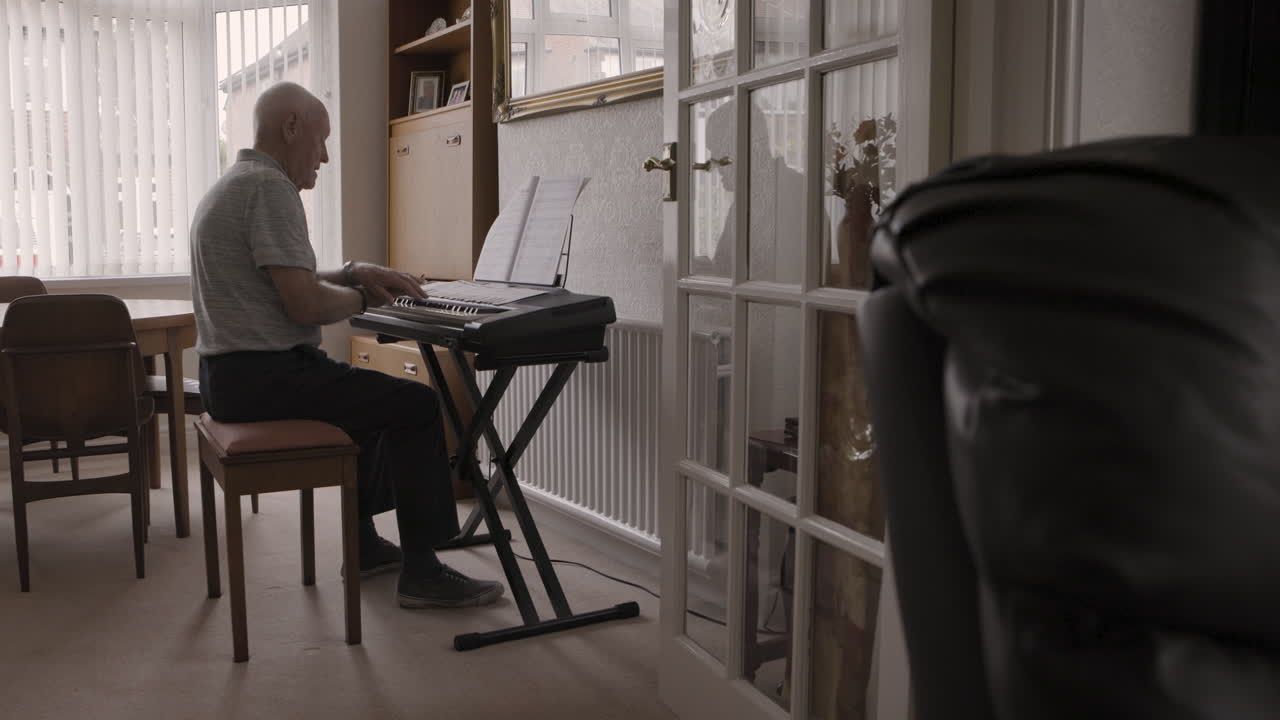Senior Man Playing Piano at Home