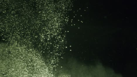 a big cloud of white powder falling trough water in slow motion.