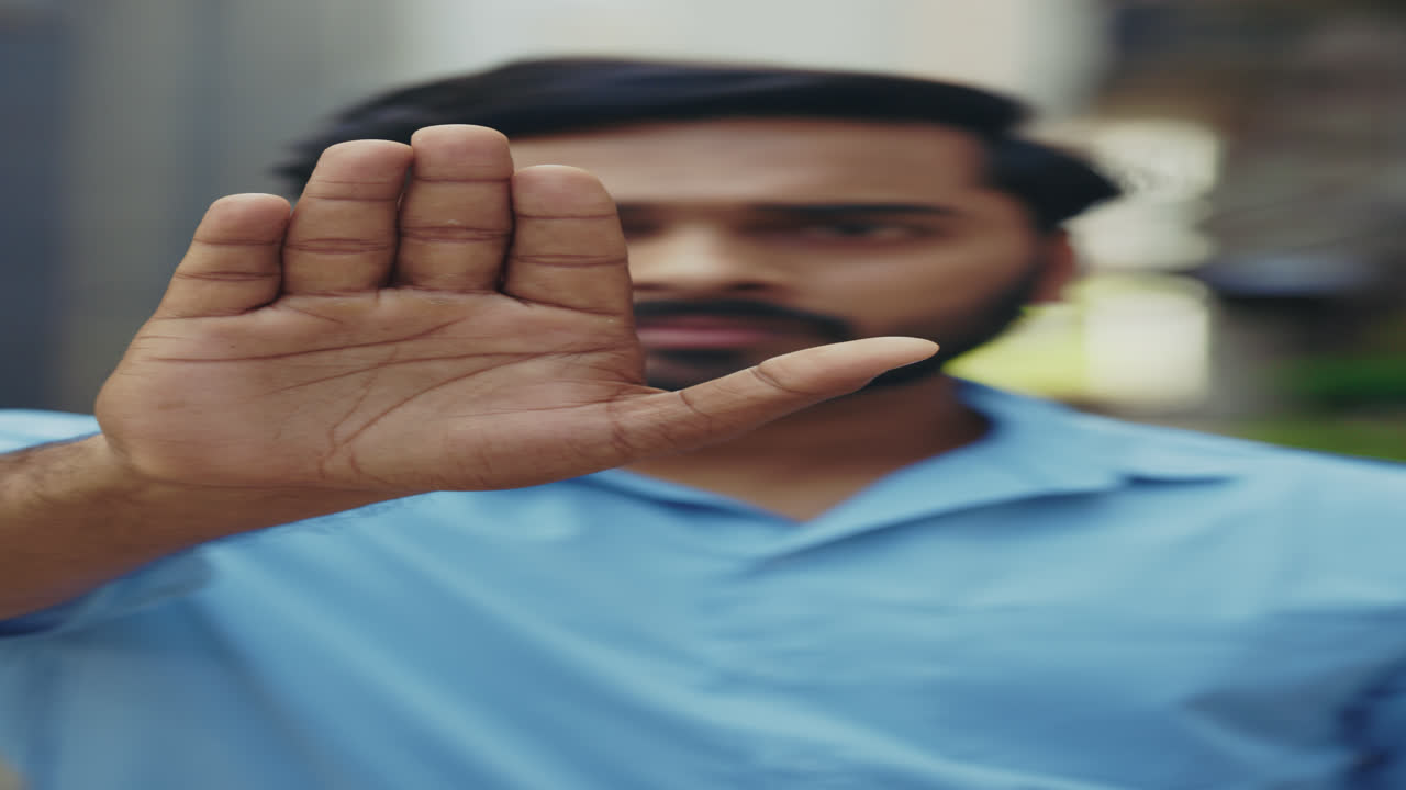 Man with hand up in a stop gesture