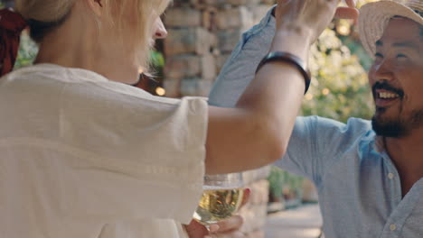 young asian man dancing with beautiful woman at summer dance party friends drinking wine enjoying summertime social gathering having fun celebrating on sunny day 4k footage