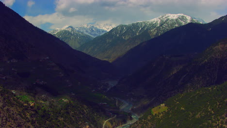 A-picturesque-village-with-beautiful-watery-scenes-round-snowy-mountains-and-river,-as-well-as-charmingly-crafted-greenery