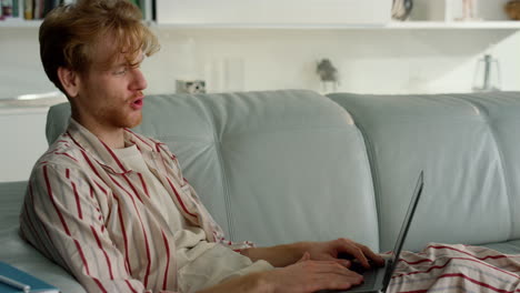 happy guy talking virtual meeting at home closeup. man enjoy video conference