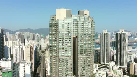 Aerial-shot-of-Downtown-Hong-Kong-mega-residential-skyscrapers-and-traffic,-on-a-beautiful-day