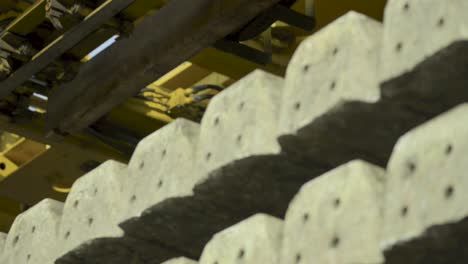 close-up of a conveyor belt in an industrial setting showing detailed texture of materials