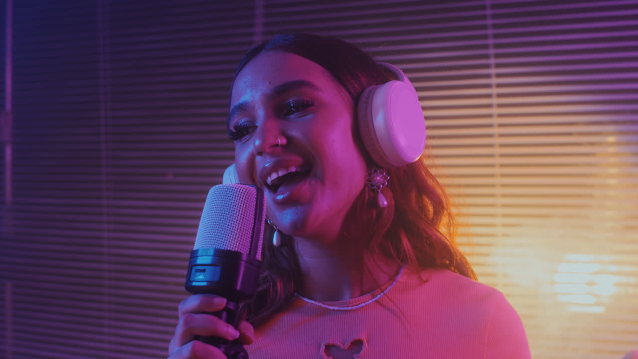 Gen Z Girl in Headphones Singing in Microphone in Karaoke