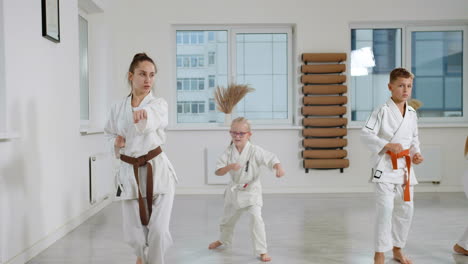 kids in white kimono in martial arts class