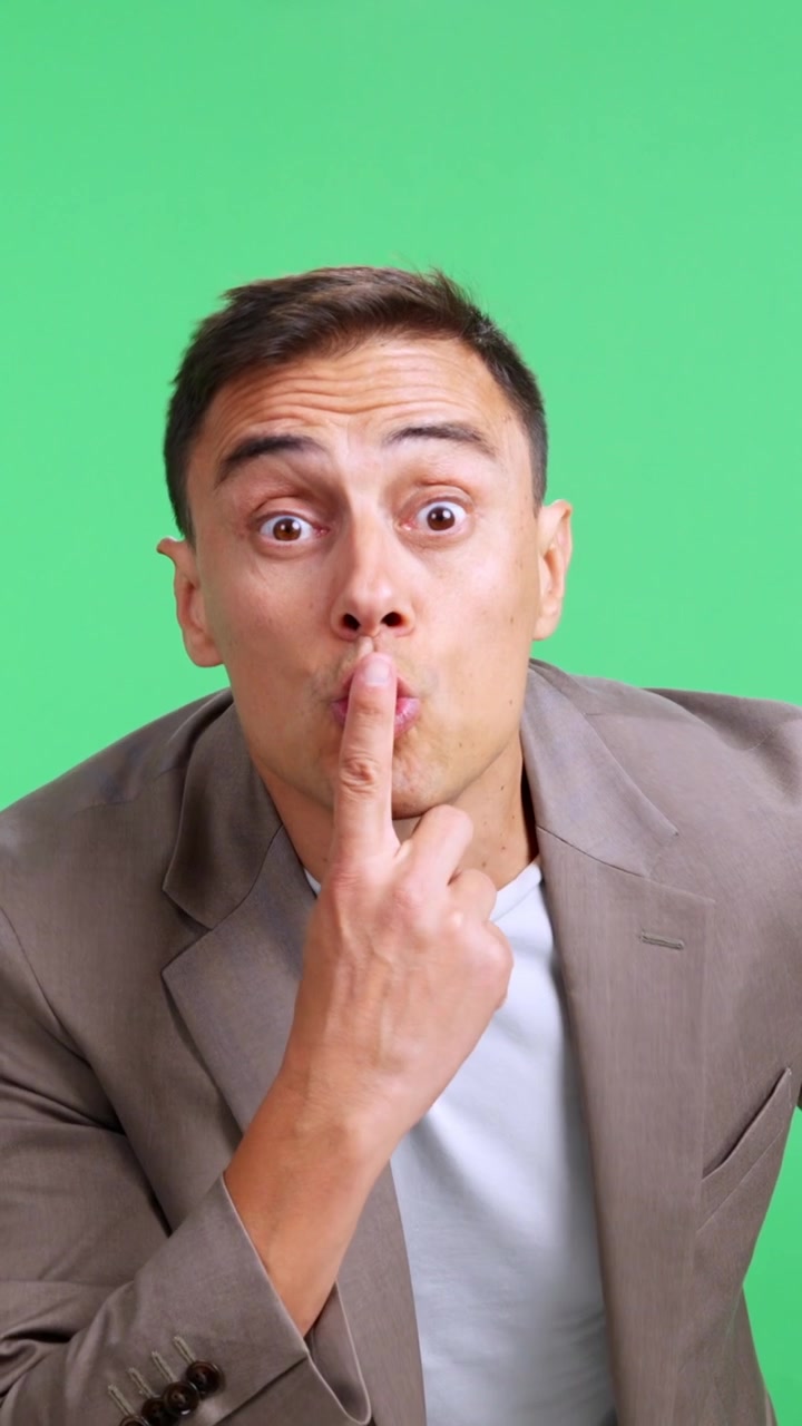 Businessman asking for silence with finger on lips