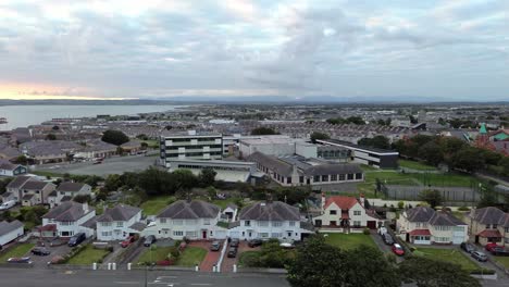 holyhead island coastal town suburb aerial view panning across to harbour docks seafront skyline