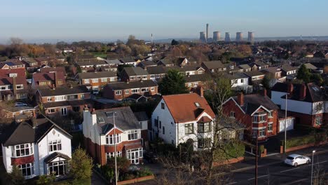 aerial view expensive british middle class houses in rural suburban neighbourhood under fiddlers ferry power station skyline