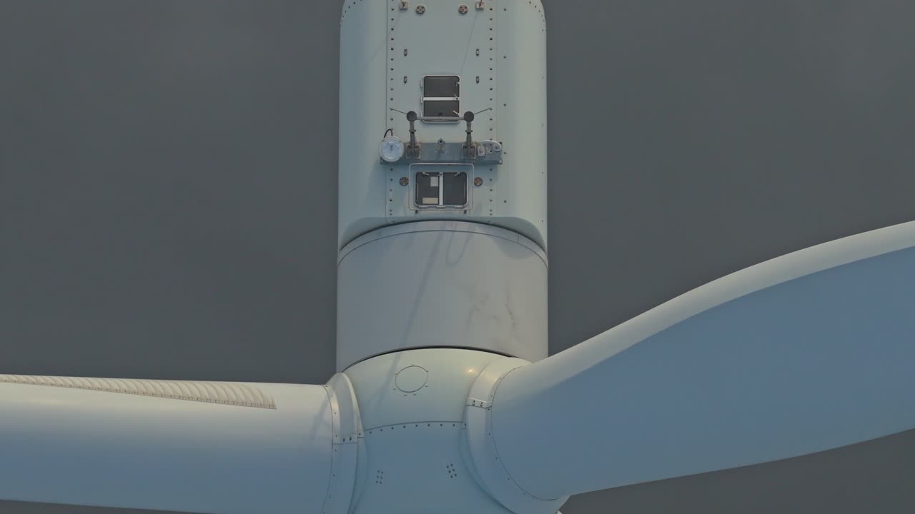 Wind turbine blades rotating in dense fog for renewable energy