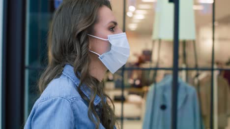 video of woman in protective mask strolling in shopping mall